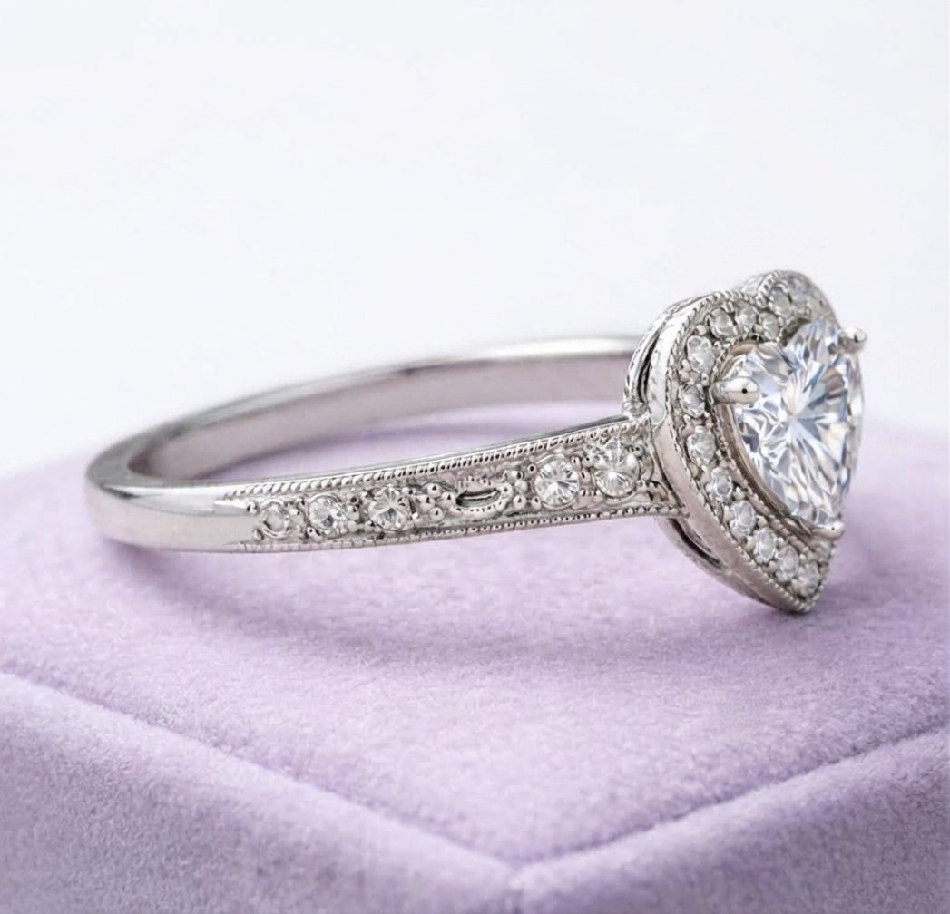 Side profile view displaying the detailed milgrain engraving and accent stones along the white gold band.