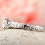 close-up-detail-of-hand-engraved-scrollwork-and-milgrain-on-diamond-ring-band