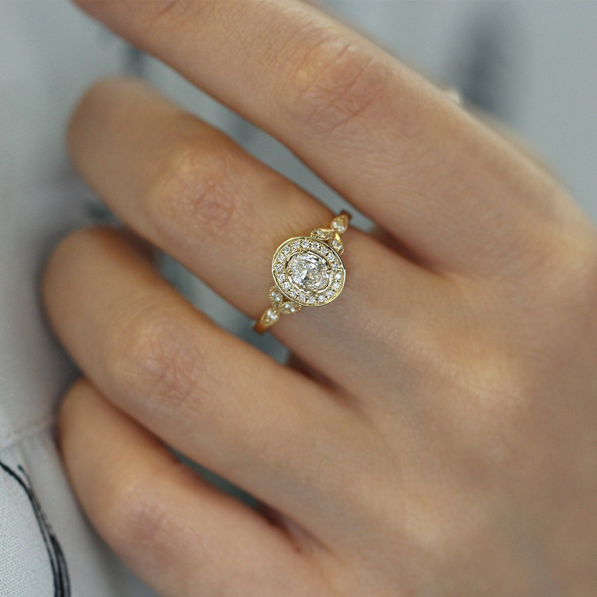 2-ct-oval-lab-grown-diamond-halo-ring-worn-on-finger-lifestyle-view