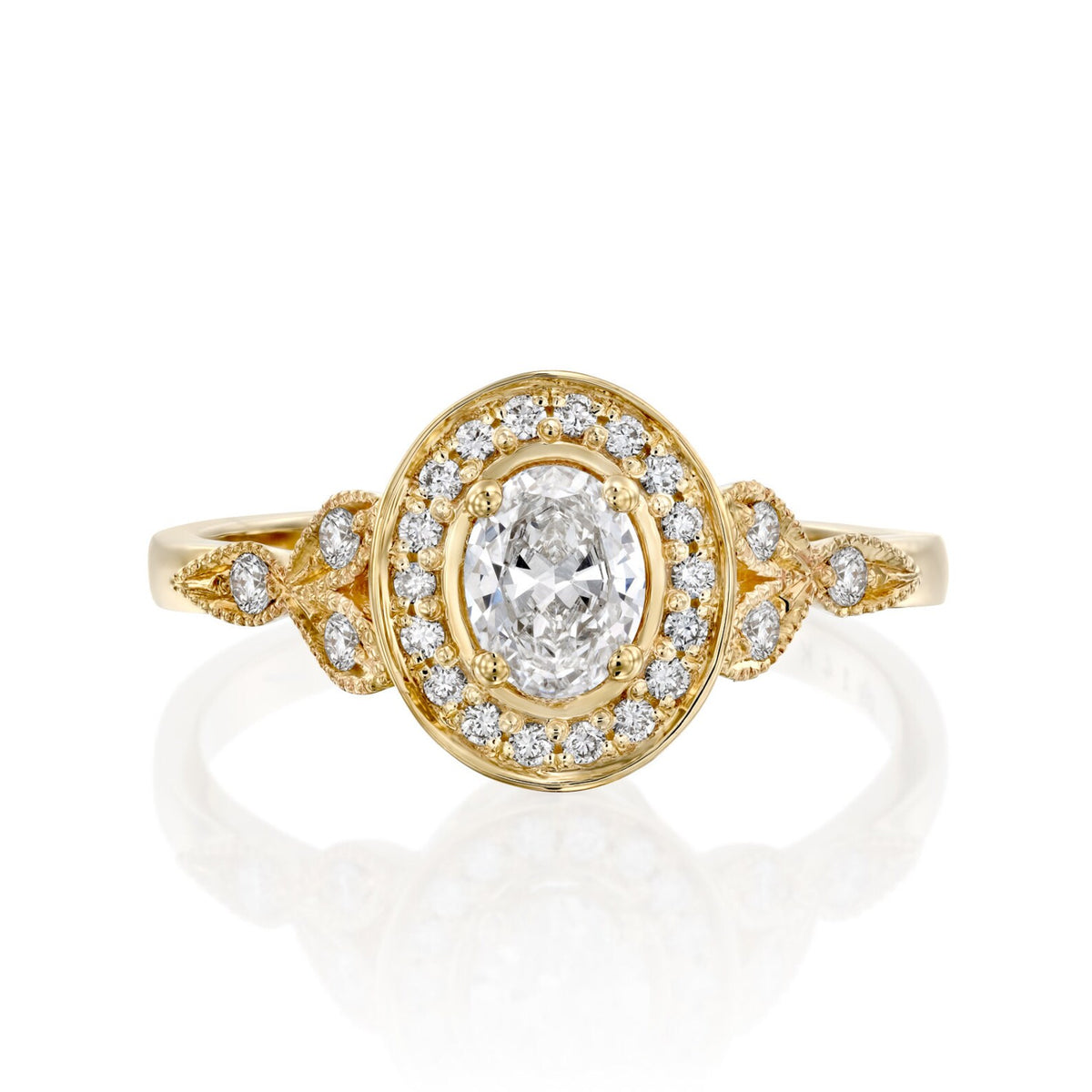 top-down-view-of-oval-cut-lab-grown-diamond-halo-engagement-ring-with-leaf-accents