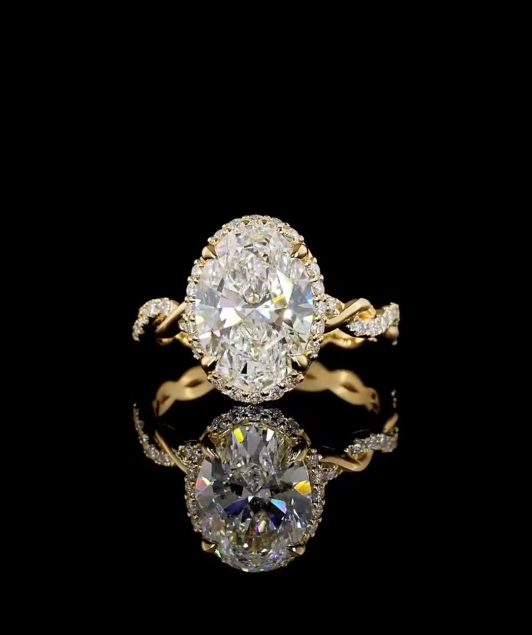 Top-down front view of a 4 carat oval cut lab grown diamond featuring a subtle hidden halo and twisted pavé yellow gold band.