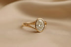 angled-profile-view-of-oval-cut-lab-diamond-bezel-ring-in-yellow-gold