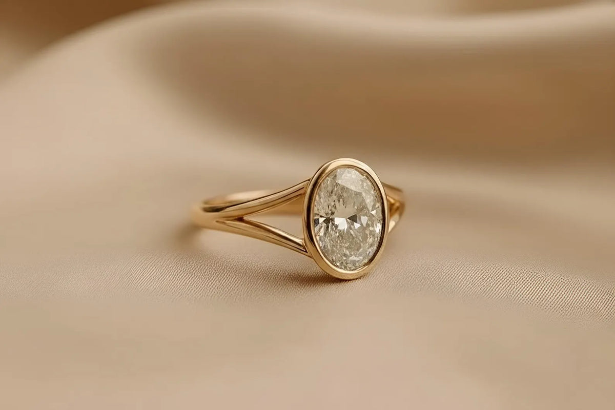 angled-profile-view-of-oval-cut-lab-diamond-bezel-ring-in-yellow-gold