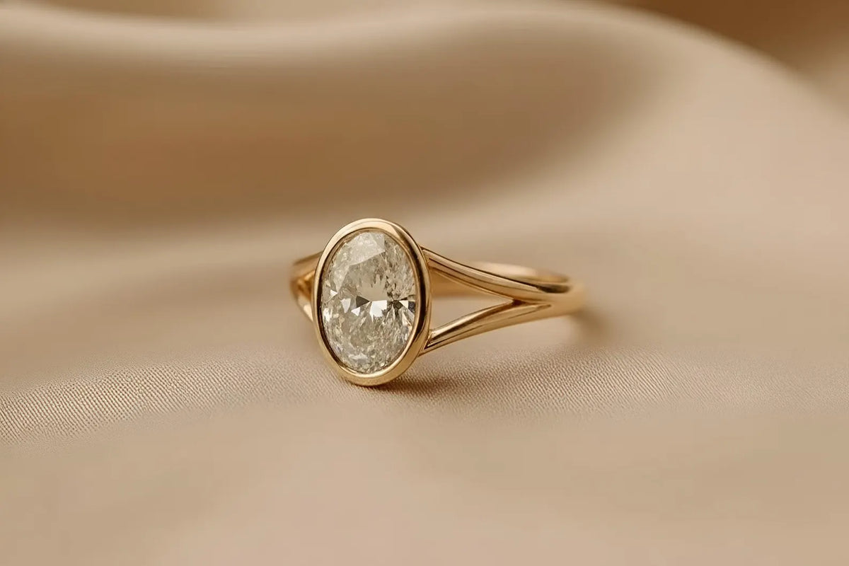 side-profile-view-of-oval-cut-lab-diamond-bezel-ring-on-silk-background