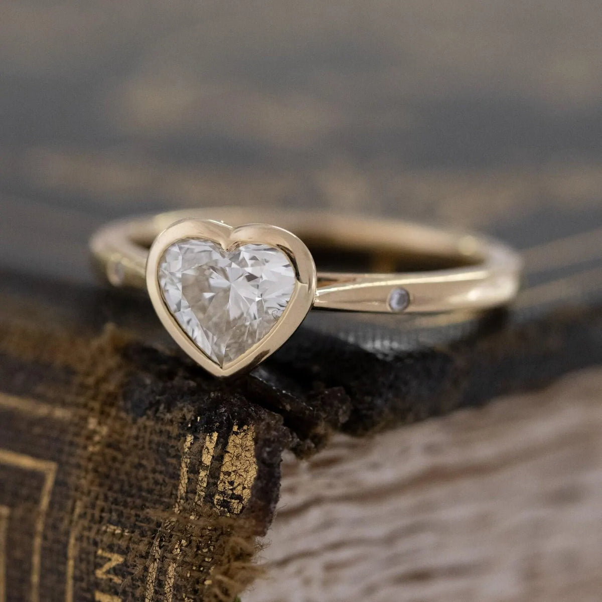 angled-macro-view-of-heart-cut-lab-diamond-bezel-engagement-ring