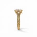 Detailed top-down view of the intricate wheat leaf engraving on the yellow gold band of an oval diamond ring.