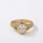 Front overhead view of a 2 carat oval cut lab-grown diamond in a bezel setting with milgrain trim.
