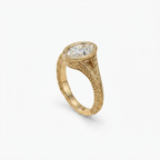 Angled perspective shot highlighting the bezel-set oval lab-grown diamond and carved gold shank.