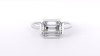 Front overhead view of a 3 carat emerald cut lab-grown diamond bezel-set solitaire ring.