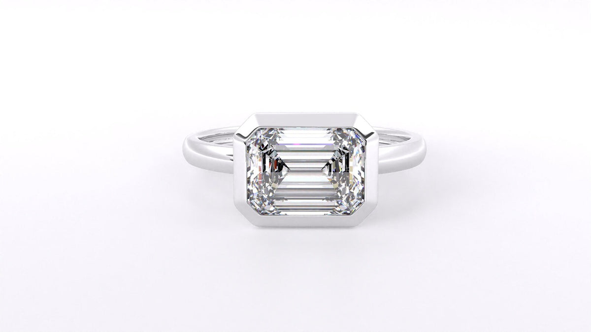 Front overhead view of a 3 carat emerald cut lab-grown diamond bezel-set solitaire ring.
