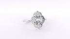 Angled side view of a 3 CT oval lab-grown diamond engagement ring featuring a vintage floral halo in white gold.