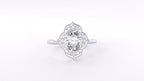 Top-down direct view of the intricate scalloped floral halo and milgrain details on an oval diamond ring.