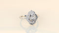 Studio presentation shot of a luxury 3 CT oval lab-grown diamond vintage halo ring on a neutral background.