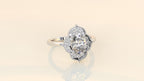 Studio presentation shot of a luxury 3 CT oval lab-grown diamond vintage halo ring on a neutral background.