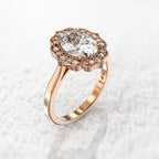 Angled side profile view of a 3 CT oval lab-grown diamond ring featuring a scalloped halo in rose gold.