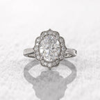 Overhead studio view of a 3 CT oval lab-grown diamond vintage halo ring crafted in white gold.