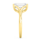 Side profile view of a 4 CT emerald cut lab-grown diamond engagement ring in yellow gold.