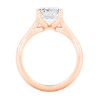 Close-up side perspective showing the gallery structure of a rose gold emerald diamond ring.