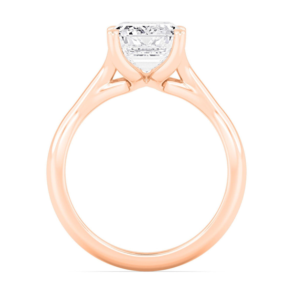 Close-up side perspective showing the gallery structure of a rose gold emerald diamond ring.