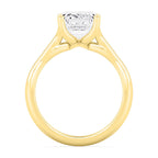 Detailed side view highlighting the basket setting of a yellow gold emerald cut diamond ring.