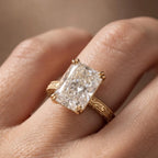 Macro close-up of a 5 carat radiant lab diamond showing brilliant facet patterns and intricate hand-carved floral band.