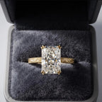Front view of a 5 carat elongated radiant lab grown diamond ring displayed inside a luxury grey velvet jewelry box.