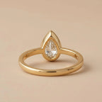 Rear view showing the smooth solid band and open gallery back of a 3 carat pear bezel lab diamond ring.