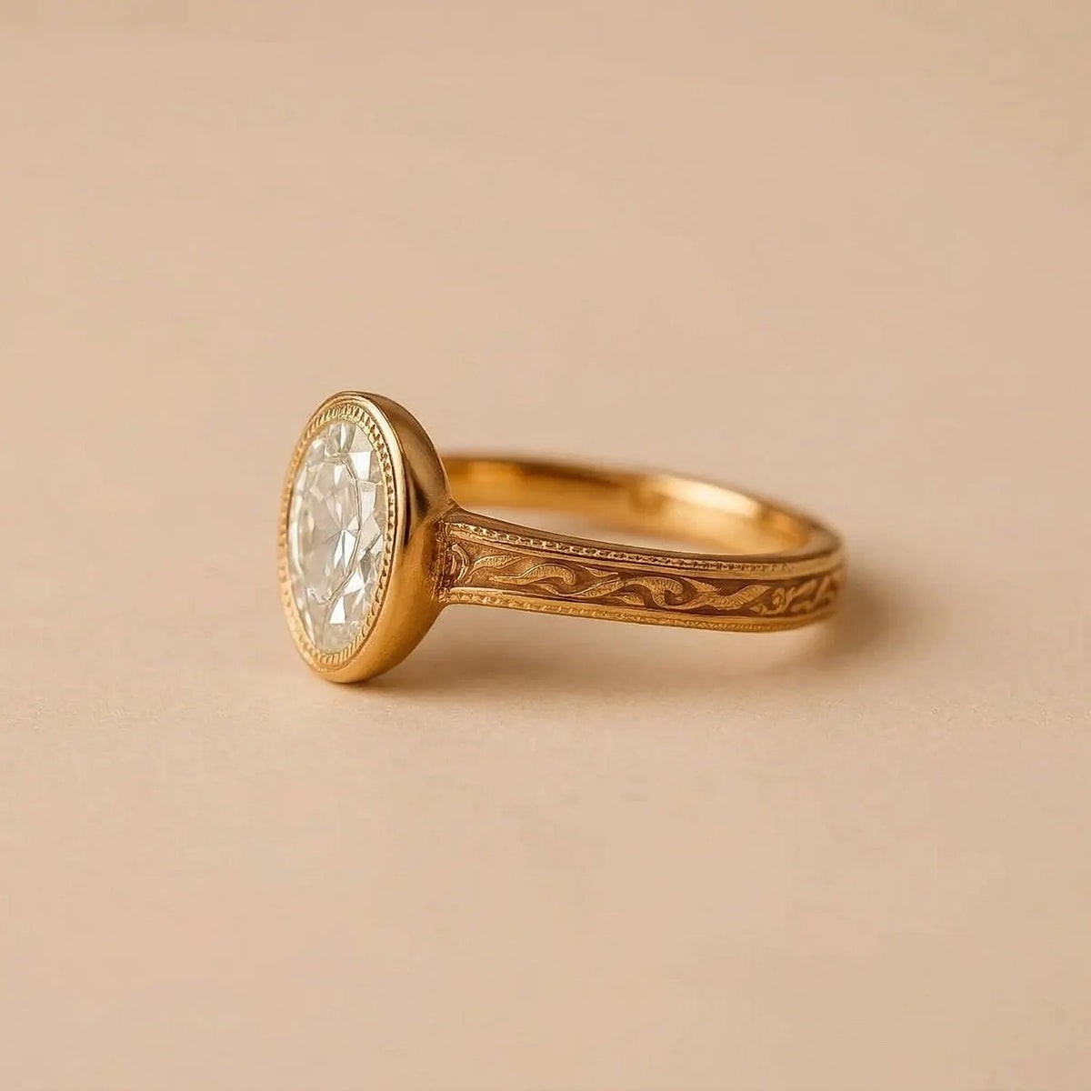 Profile perspective highlighting the hand-carved floral scrollwork on the yellow gold band of an oval bezel ring.