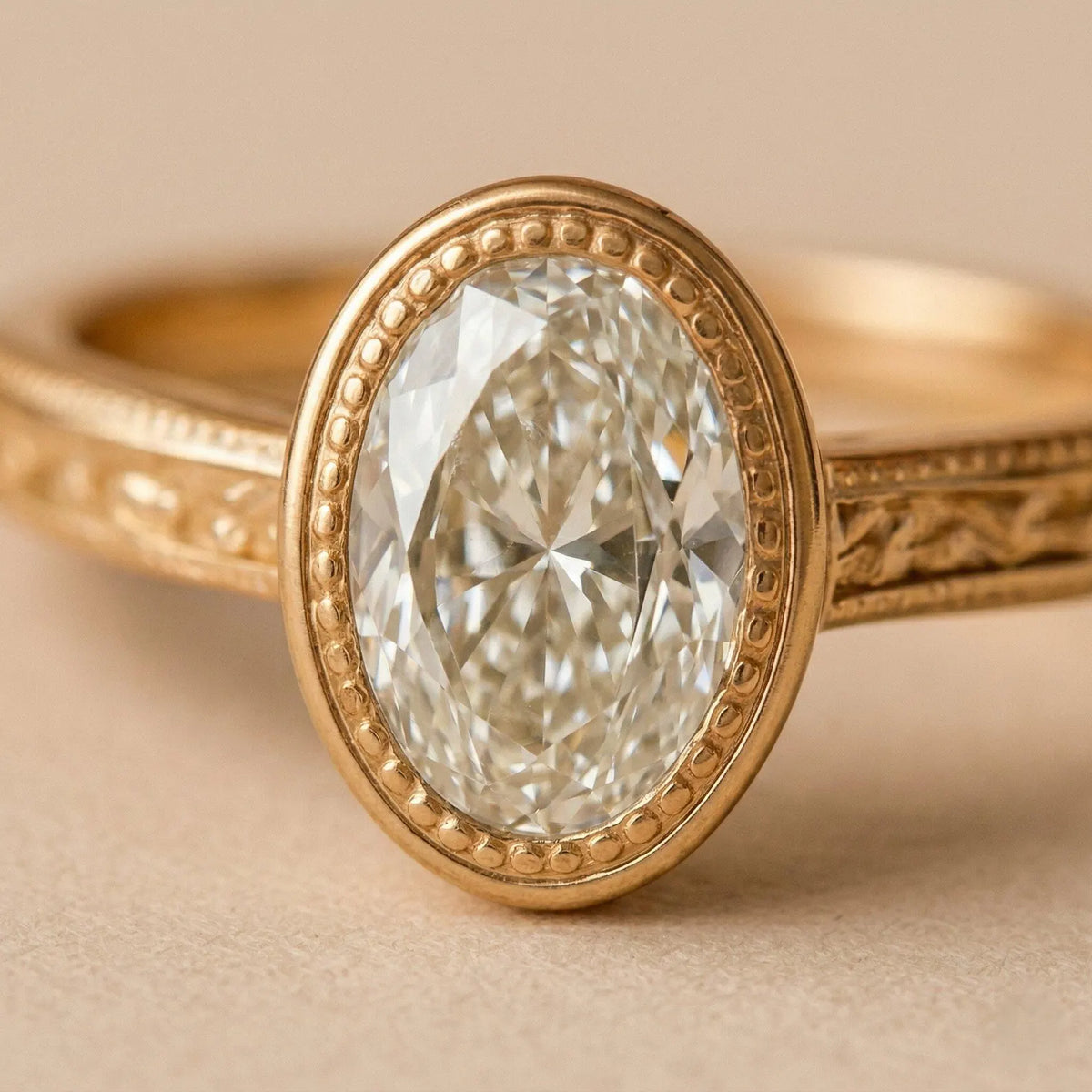 Macro close-up shot showing light reflection inside a 2 CT oval lab diamond with detailed milgrain bezel border.