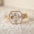 Top-down view of an IGI certified 3 carat Asscher cut lab-grown diamond featuring step-cut facets and a delicate milgrain bezel frame.