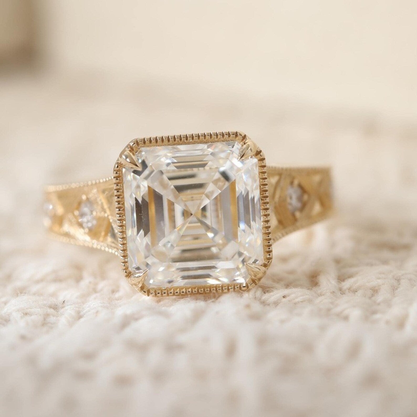 Top-down view of an IGI certified 3 carat Asscher cut lab-grown diamond featuring step-cut facets and a delicate milgrain bezel frame.
