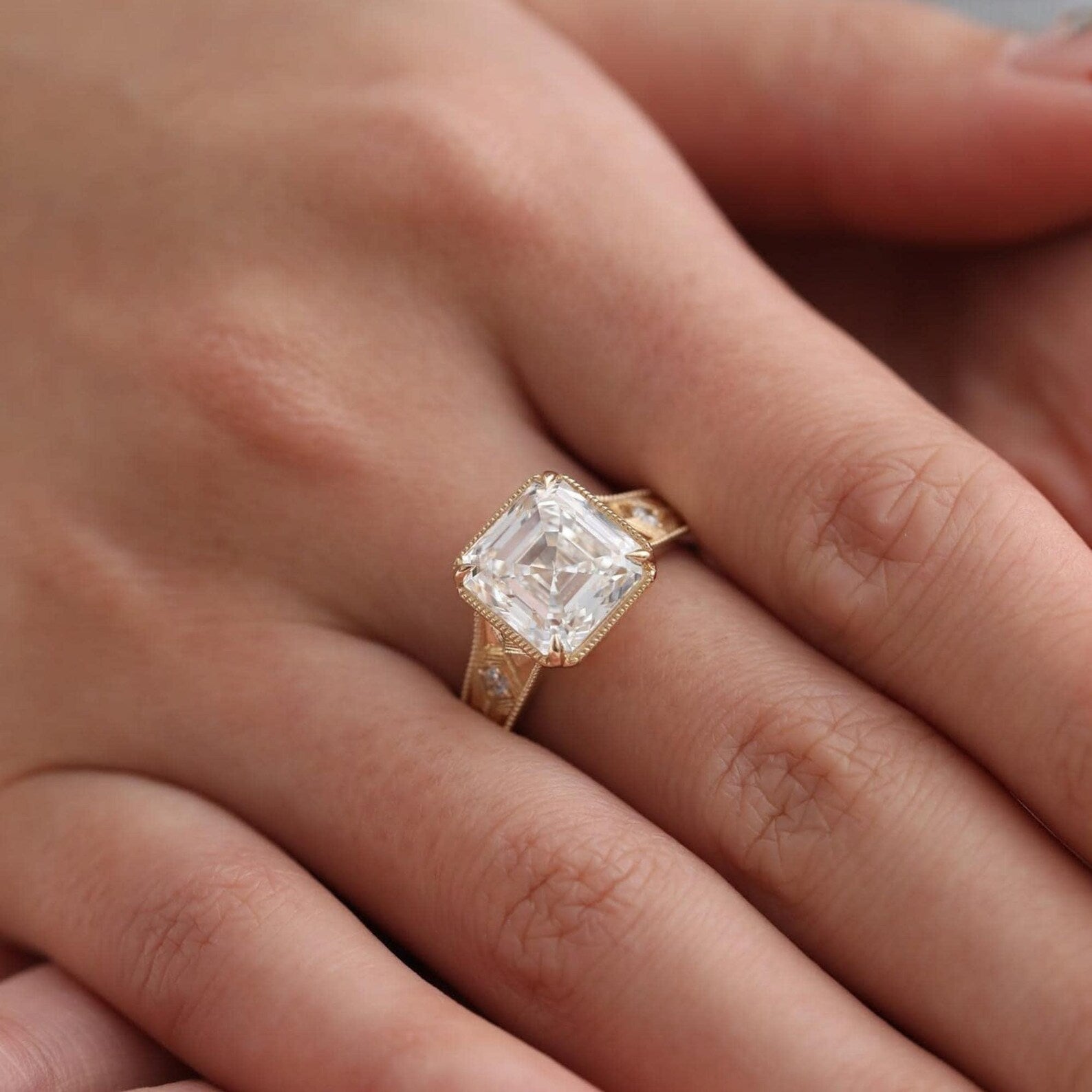 Ring Wear on finger milgrain bezel setting and vintage geometric gold band.