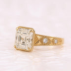 Asscher Cut hand-engraved chevron pattern band set with bezel round accent diamonds.