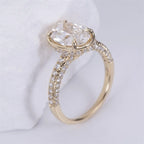 Side angle of a 3 CT oval lab-grown diamond engagement ring in 14K yellow gold with a micro-pavé band and hidden halo.