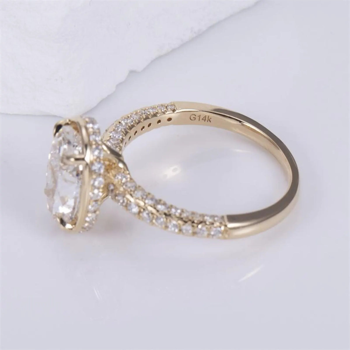 Inside shank view of a 14K yellow gold oval lab-grown diamond ring showing the G14k quality hallmark stamp.