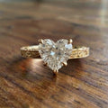 Front view of a 2 CT heart-shaped lab-grown diamond engagement ring with hand-engraved vintage scrollwork on a yellow gold band.