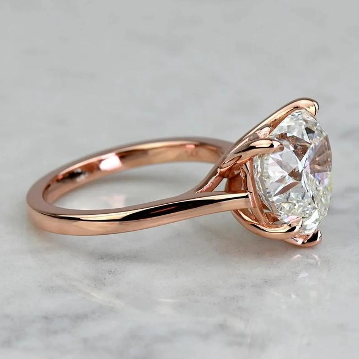 Side profile of a 3 CT heart lab-grown diamond engagement ring in polished 14K rose gold with cathedral setting.