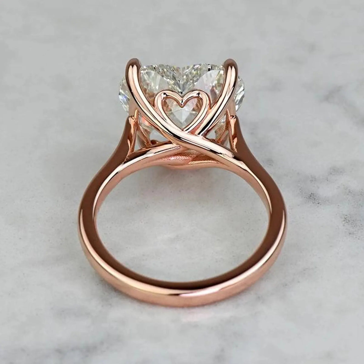Under-gallery detail shot showing the sculpted heart motif basket in a 3 CT rose gold heart diamond ring.