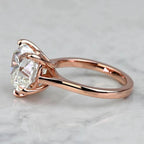 Side view of a 3 CT heart lab diamond ring showing the smooth 14K rose gold band and cathedral shoulders.