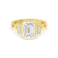 Direct overhead view of a 4 carat emerald cut lab diamond three-stone bezel setting in yellow gold.