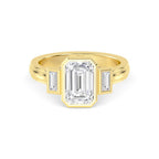 Direct overhead view of a 4 carat emerald cut lab diamond three-stone bezel setting in yellow gold.