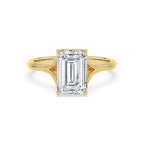 Top front view of a 4 CT emerald cut lab diamond solitaire ring with a split cathedral band in 14K yellow gold.