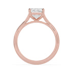 Side profile view of a 4 CT emerald cut lab-grown diamond ring in 14K rose gold with an open gallery basket setting.