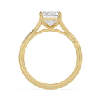 Side arch profile of a 4 carat emerald cut lab-grown diamond solitaire engagement ring in yellow gold.