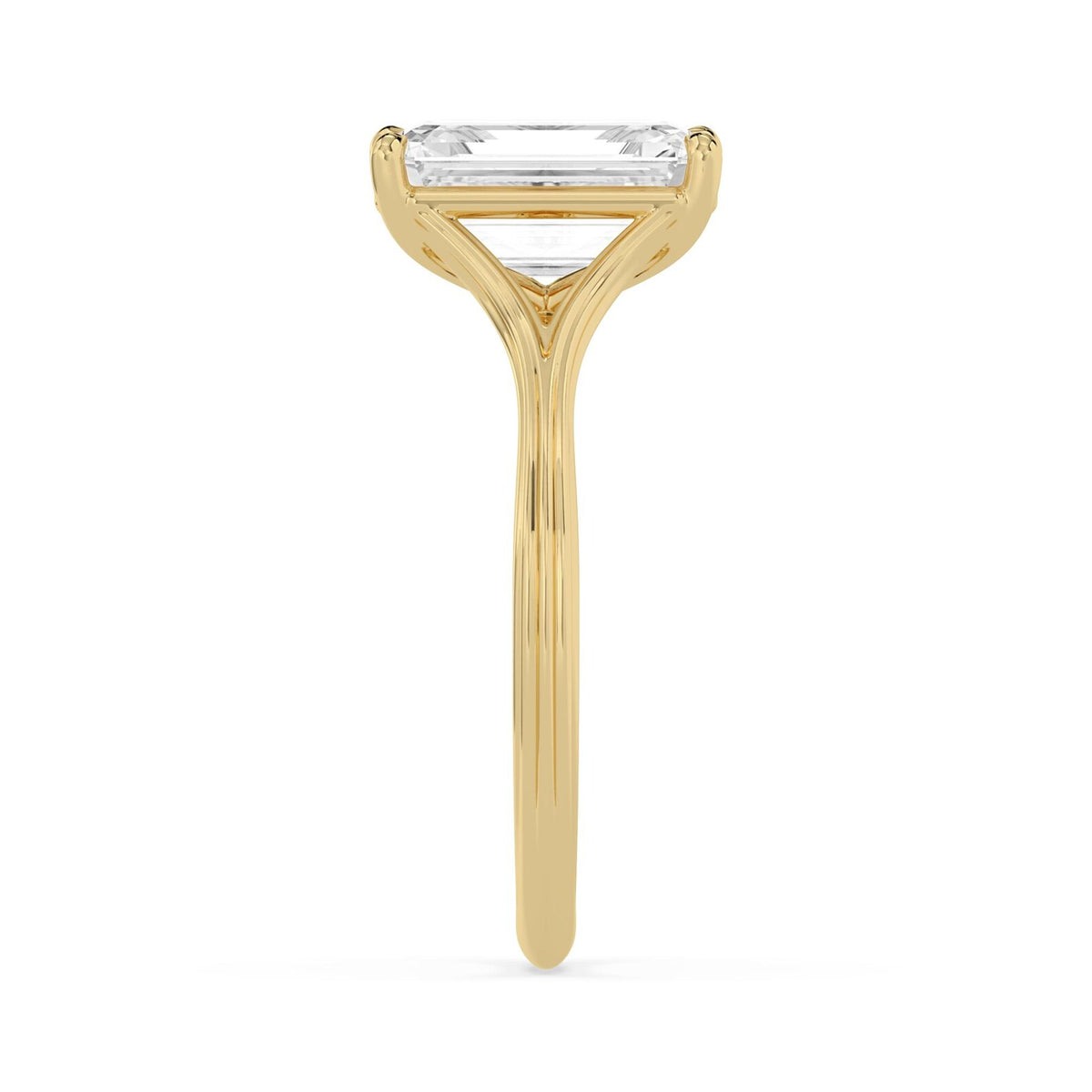 Side view of a 4 CT emerald cut lab diamond ring in yellow gold demonstrating the grooved split band detailing.