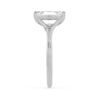 Side profile of a 4 carat emerald cut lab-grown diamond solitaire ring in white gold showing cathedral arch depth.