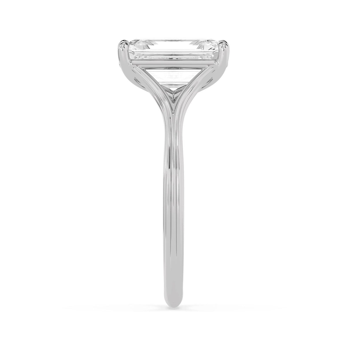 Side profile of a 4 carat emerald cut lab-grown diamond solitaire ring in white gold showing cathedral arch depth.