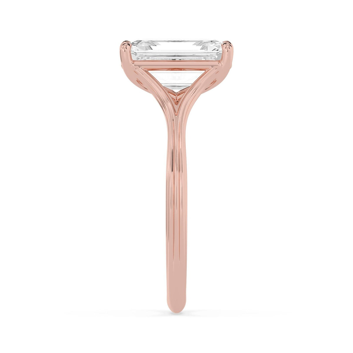 Side profile view of a 4 CT emerald cut lab diamond engagement ring in rose gold with polished band contours.