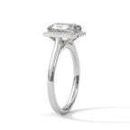 Angled side profile view of a 4 CT emerald cut lab-grown diamond engagement ring with a micro-pave frame halo in 14K white gold.