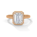 Top front view of a 4 CT emerald cut lab-grown diamond engagement ring with a pave halo frame in 14K rose gold.